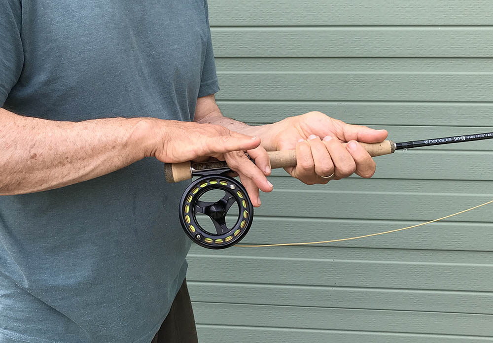 Hand position with rod and feel showing palming the spool